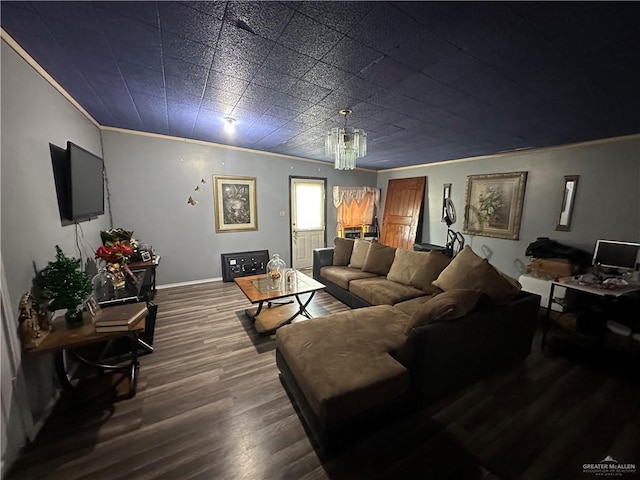 living room with hardwood / wood-style floors, a notable chandelier, and ornamental molding