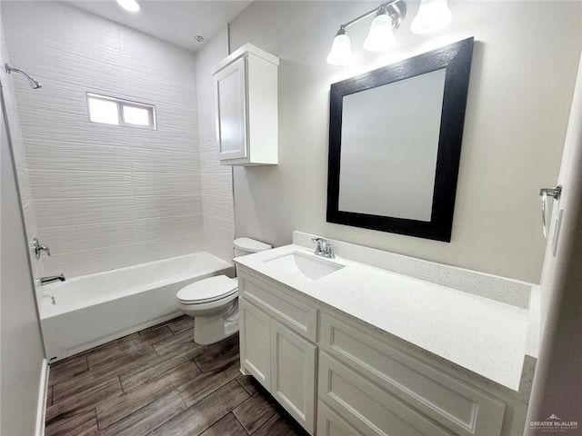 full bathroom featuring vanity, toilet, and tiled shower / bath combo