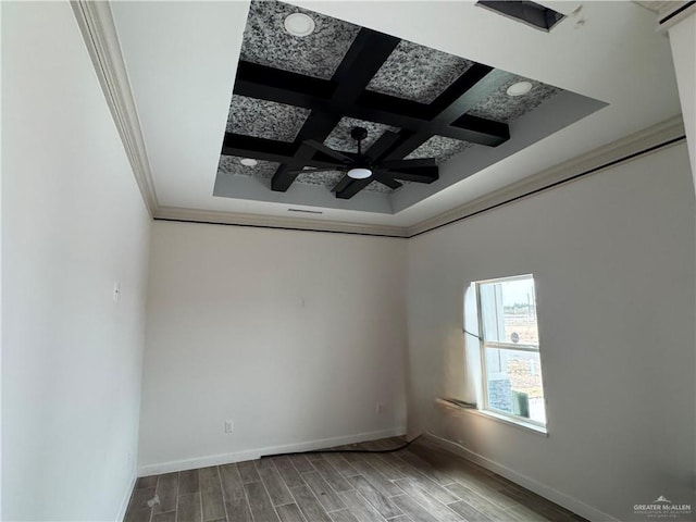 empty room with beamed ceiling, crown molding, coffered ceiling, and ceiling fan