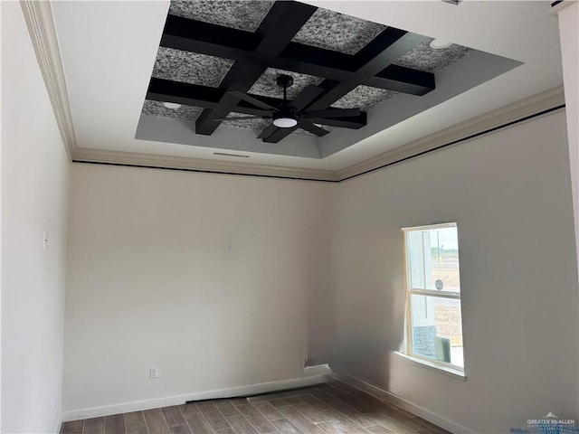 unfurnished room featuring crown molding, ceiling fan, beam ceiling, coffered ceiling, and wood-type flooring