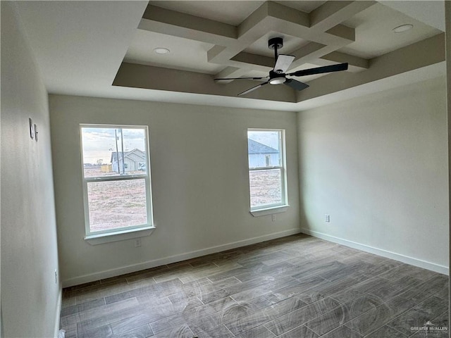 unfurnished room with ceiling fan and coffered ceiling