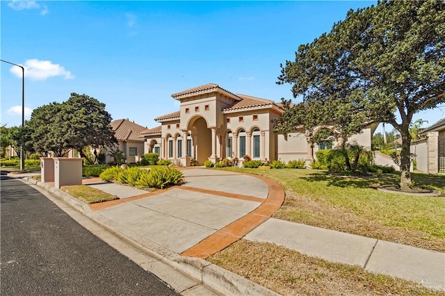 mediterranean / spanish house with a front lawn