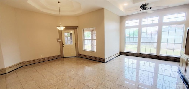 entryway featuring a baseboard radiator, a raised ceiling, and ceiling fan