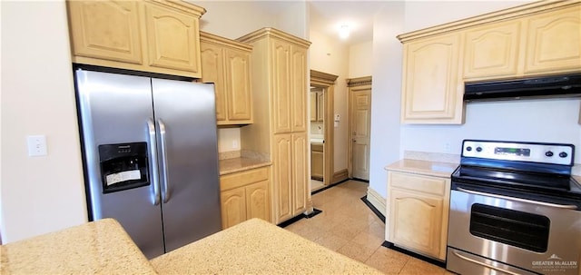 kitchen with stainless steel appliances and light brown cabinetry