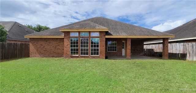 back of house with a patio area and a yard