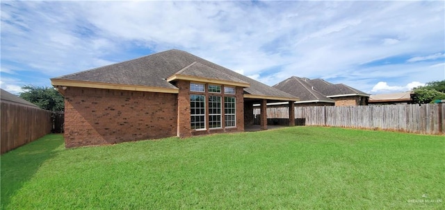 back of house with a lawn