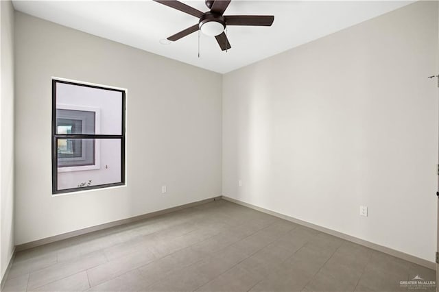 tiled empty room featuring ceiling fan