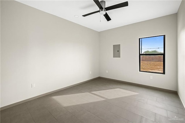 tiled empty room with electric panel and ceiling fan