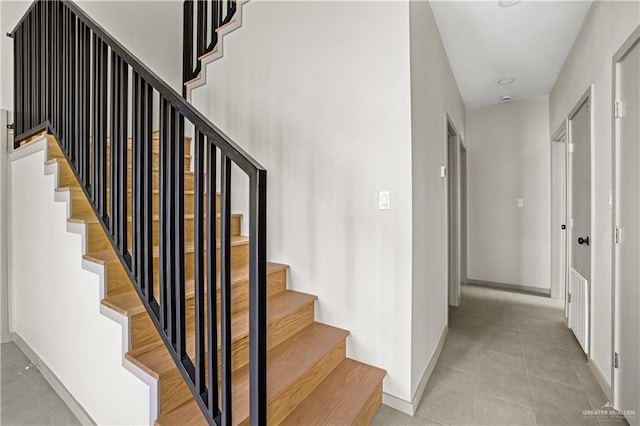 stairs featuring tile patterned flooring