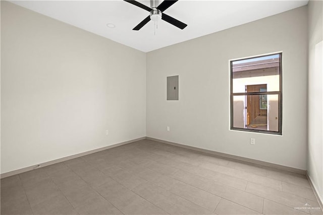 tiled empty room with electric panel and ceiling fan