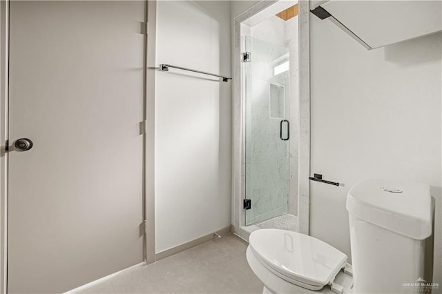 bathroom with tile patterned floors, a shower with door, and toilet