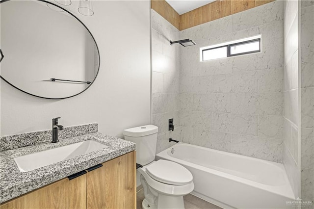 full bathroom featuring vanity, tiled shower / bath combo, and toilet