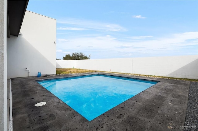 view of swimming pool featuring a fenced in pool, a patio area, and a fenced backyard