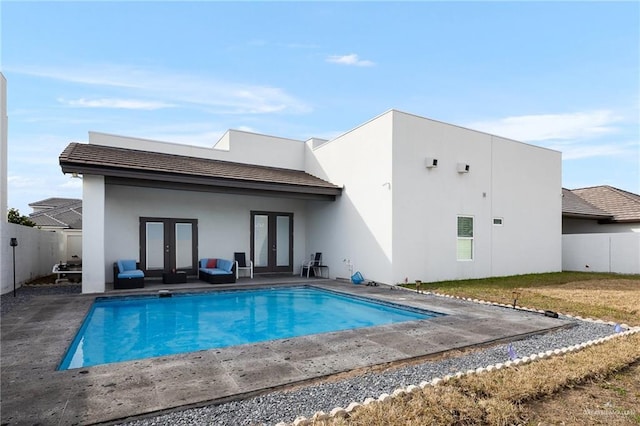 view of swimming pool featuring french doors, a fenced backyard, a fenced in pool, and a patio