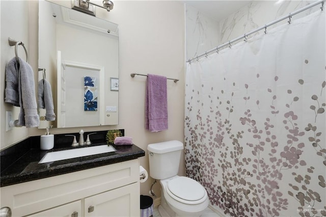 full bathroom with vanity, a shower with shower curtain, and toilet