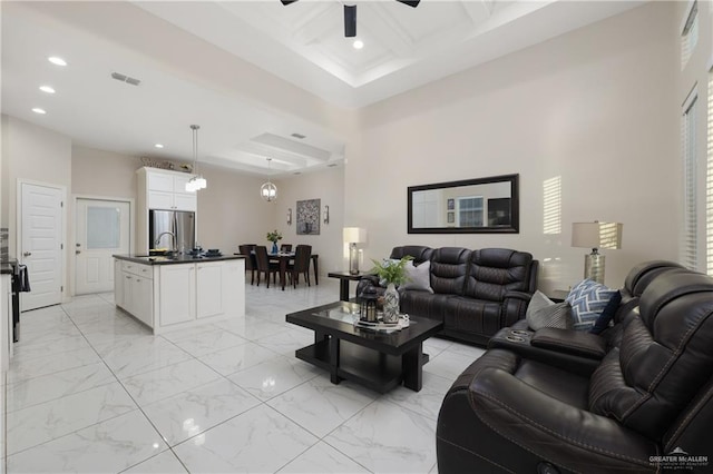 living room featuring a ceiling fan, visible vents, recessed lighting, and coffered ceiling