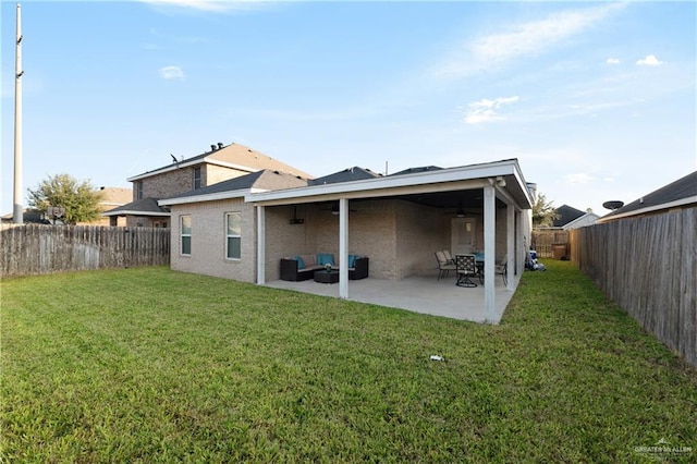 back of house featuring a lawn, a fenced backyard, an outdoor hangout area, and a patio area