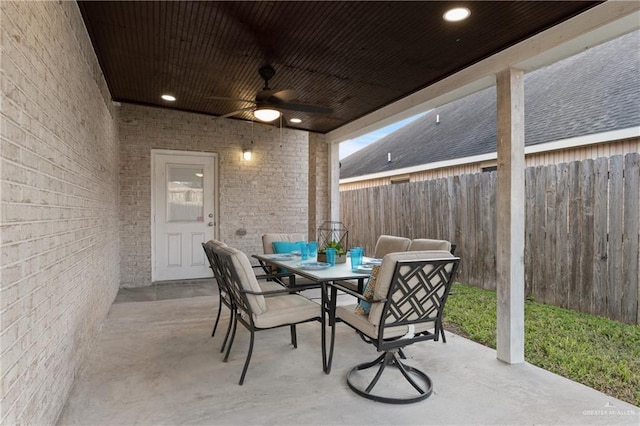 view of patio / terrace featuring a fenced backyard, a ceiling fan, and outdoor dining space