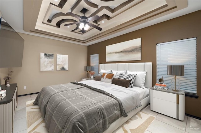 tiled bedroom featuring crown molding, ceiling fan, and a raised ceiling