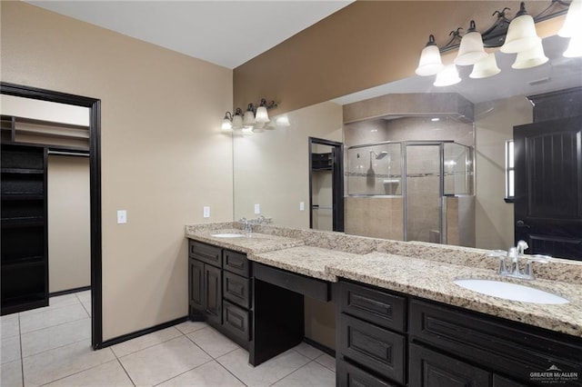 bathroom featuring tile patterned floors, an enclosed shower, and vanity