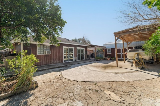 back of property with cooling unit, french doors, and a patio