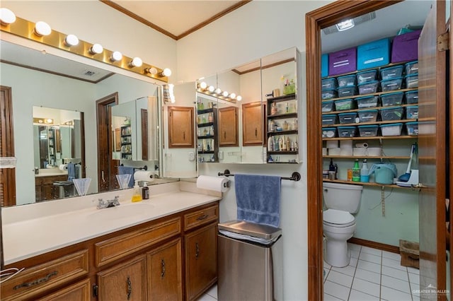 bathroom with visible vents, toilet, ornamental molding, tile patterned flooring, and vanity