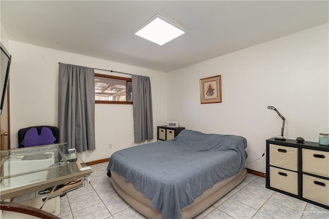 bedroom featuring baseboards and light tile patterned flooring