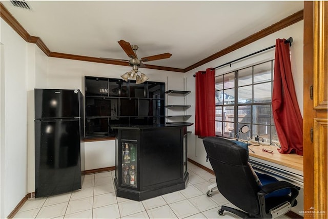 kitchen featuring baseboards, visible vents, ceiling fan, freestanding refrigerator, and crown molding