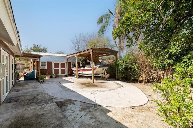 view of patio / terrace featuring a storage shed, an outdoor structure, and fence