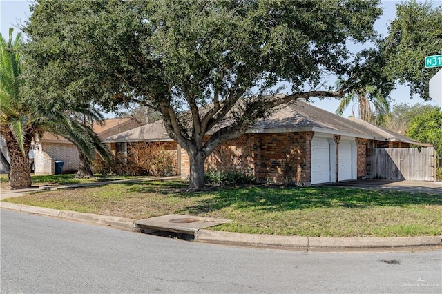 single story home featuring a garage, a front yard, fence, and brick siding