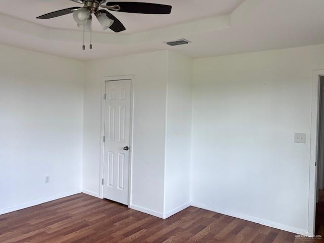 1056 E Mile 11 N, Weslaco, TX 78599 - empty room with a ceiling fan and dark wood-type flooring