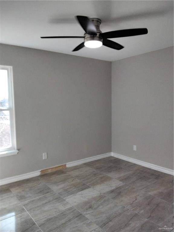 3018 Greenwood Dr, Corpus Christi, TX 78405 - unfurnished room featuring a ceiling fan, baseboards, and a healthy amount of sunlight