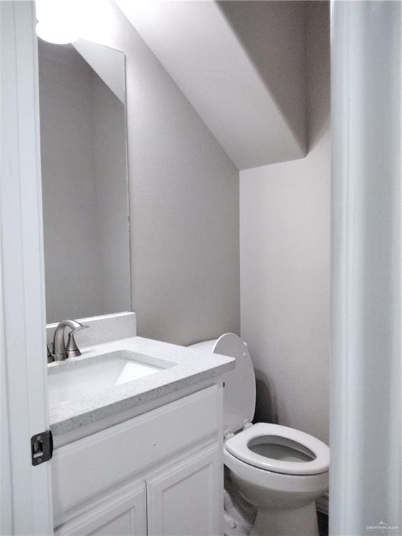 3018 Greenwood Dr, Corpus Christi, TX 78405 - bathroom with lofted ceiling, toilet, and vanity