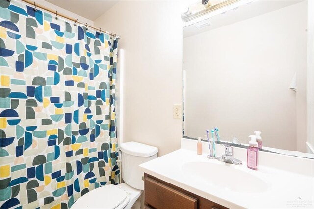 3292 Turquia St, Brownsville, TX 78520 - bathroom with vanity, toilet, and a shower with curtain