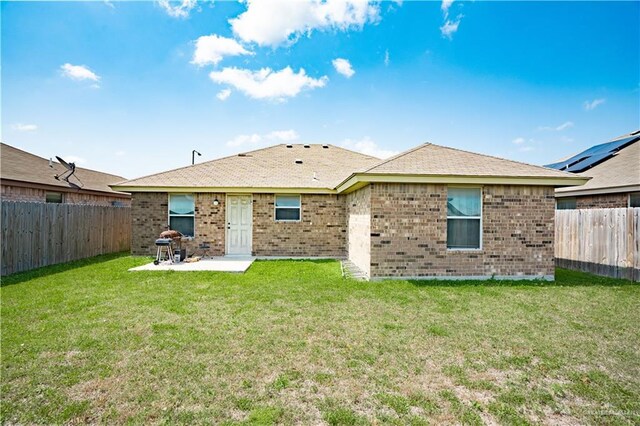 3292 Turquia St, Brownsville, TX 78520 - rear view of house featuring brick siding, a fenced backyard, a patio area, and a lawn