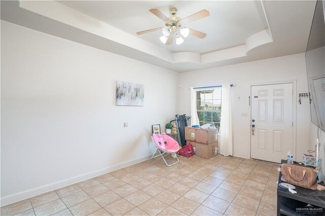 3292 Turquia St, Brownsville, TX 78520 - interior space with light tile patterned floors, baseboards, ceiling fan, and a tray ceiling