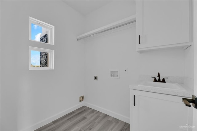 laundry room featuring sink, cabinets, electric dryer hookup, hookup for a washing machine, and light hardwood / wood-style floors