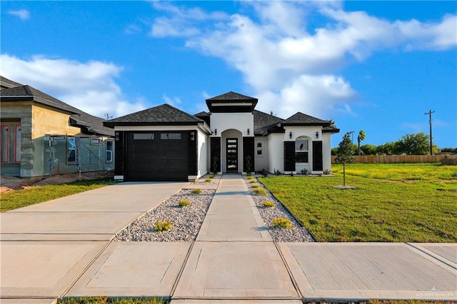 view of front of house featuring a front lawn and a garage