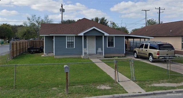 view of front of house with a gate, driveway, a front lawn, and a fenced front yard