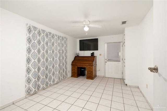 unfurnished living room with ceiling fan and light tile patterned flooring