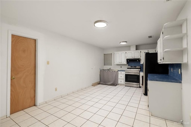 kitchen with light tile patterned flooring, white cabinets, and appliances with stainless steel finishes