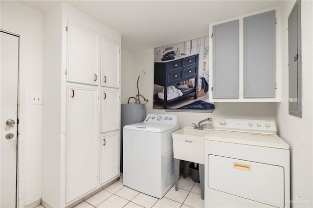 washroom with cabinets, light tile patterned flooring, washing machine and clothes dryer, and water heater