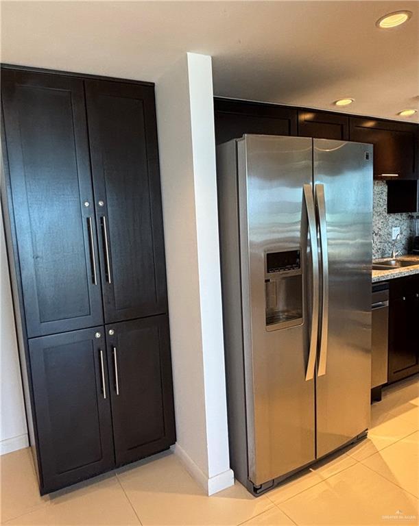 2100 Gulf Blvd, South Padre Island, TX 78597 - kitchen with appliances with stainless steel finishes, backsplash, light tile patterned floors, recessed lighting, and light countertops