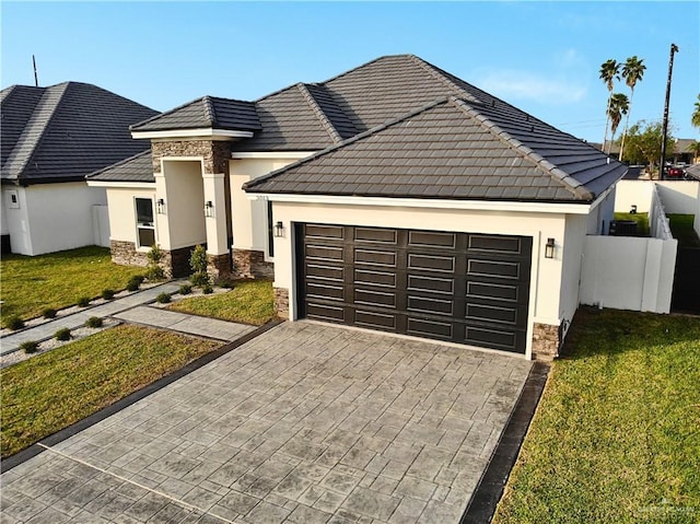 view of front of house with a front yard and a garage