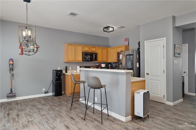 kitchen featuring light wood-type flooring, pendant lighting, stainless steel fridge with ice dispenser, and light brown cabinets