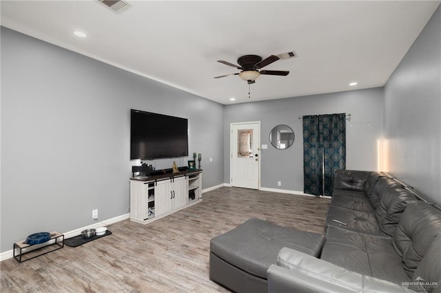 living room with ceiling fan and light wood-type flooring