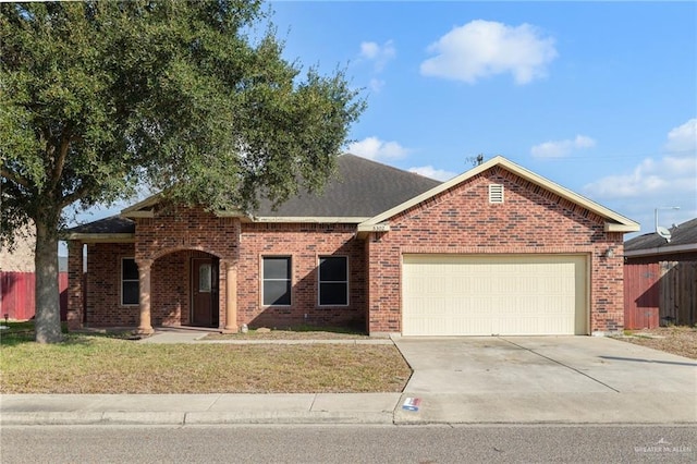 view of front of property featuring a garage and a front lawn