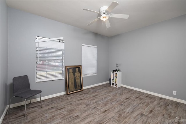 spare room featuring dark wood-type flooring and ceiling fan