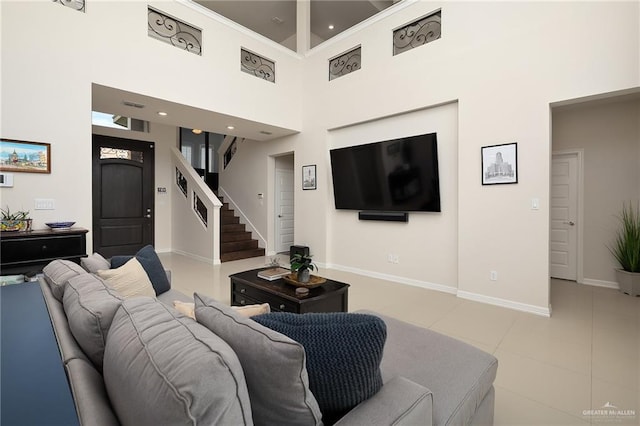 2509 Mcleod Ave, Edinburg, TX 78539 - living area with baseboards, a high ceiling, stairs, and light tile patterned floors