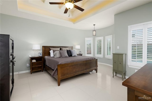 2509 Mcleod Ave, Edinburg, TX 78539 - bedroom with a raised ceiling, baseboards, ceiling fan, and light tile patterned floors